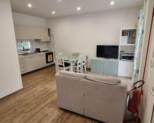 a living room with a couch and a table and a kitchen at San Paolo Hideout in Rome