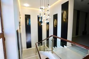 a lobby with a staircase and a chandelier at Sherline Hotel in Urganch +49 photos