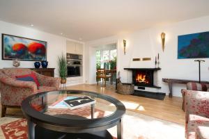 a living room with a table and a fireplace at Haus Hideaway in Westerland (Sylt)