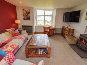 a living room with a couch and a coffee table at Boxwood Cottage in Troutbeck