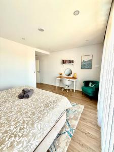 a bedroom with a bed and a desk and a couch at Valadares House in Corroios +40 photos