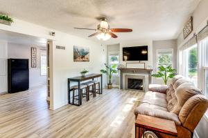 a living room with a couch and a fireplace at Half-Mi to Dtwn Yankton and River Charming Home! in Yankton