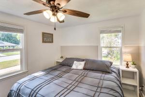 a bedroom with a bed with a ceiling fan at Half-Mi to Dtwn Yankton and River Charming Home! in Yankton