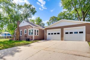 a house with two garage doors and a driveway at Half-Mi to Dtwn Yankton and River Charming Home! in Yankton