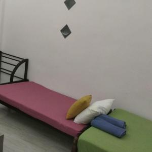 a bedroom with two beds with colorful sheets at Rooms in galle in Galle