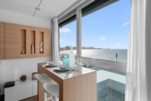 a kitchen with a view of the ocean at Beachfront Oceanview Wifi Self Check in in San Juan