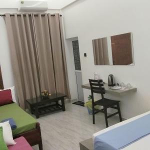 a living room with a couch and a table at Rooms in galle in Galle