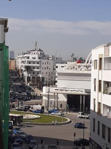 a city with cars parked in a parking lot at Chambre au centre de Rabat in Rabat