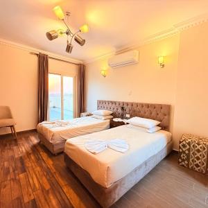 a hotel room with two beds and a window at Five Pyramids Peaks View in Cairo