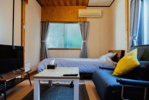 a living room with a couch and a tv at Atami Ajiro no kaze - Vacation STAY 40583v in Atami