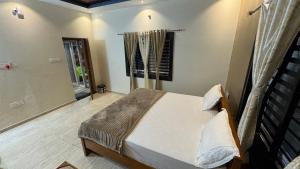 a bedroom with a bed and a window at Hampi Palace in Hampi +17 photos