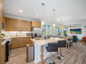 a kitchen with a large island in the middle at Kalo Homes - Makaha Modern in Makaha Valley
