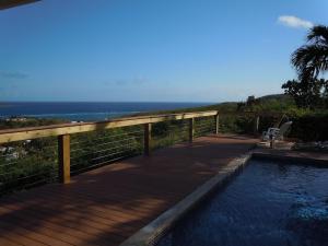 una piscina en una terraza con vistas al océano en Blue Horizon-Cotton Valley, en Christiansted