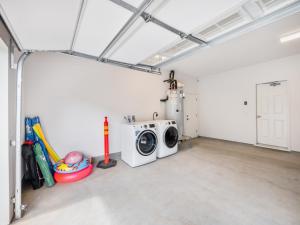 a laundry room with a washing machine in it at Kalo Homes - Makaha Modern in Makaha Valley