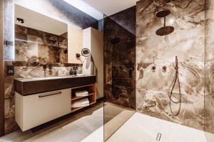 a bathroom with a sink and a shower at Dillhof Apartments in Eschau +33 photos
