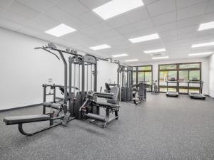 a gym with several treadmills and machines in a room at Breath of Life by Kalo Homes in Makaha Valley