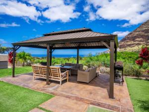 a wooden gazebo with a table and chairs at Kalo Homes - Immersed in Aloha in Makaha Valley