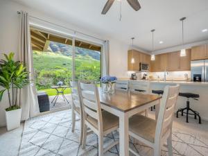 a kitchen and dining room with a table and chairs at Kalo Homes - Makaha Mountain Hideaway in Makaha Valley