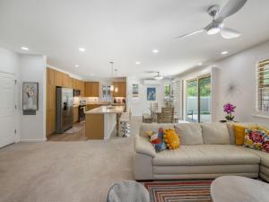 a living room with a couch and a kitchen at Kalo Homes - Elevated Escape in Makaha Valley