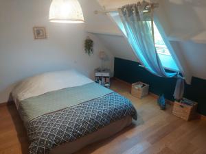 a bedroom with a bed and a window at Ker Raphaël in Guérande