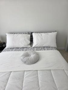 a large white bed with a pillow on it at Modern Stylish Cozy Home Balcony Wifi in Caledonia