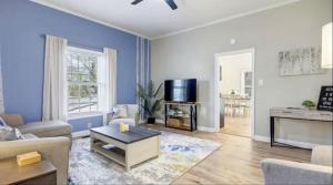a living room with a couch and a tv at Mins to Downtown, Hospital, Airport in Greenville