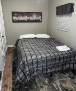 a bed with two pillows on it in a room at Mins to Downtown, Hospital, Airport in Greenville