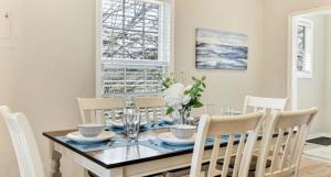 a dining room with a wooden table and chairs at Mins to Downtown, Hospital, Airport in Greenville +6 photos