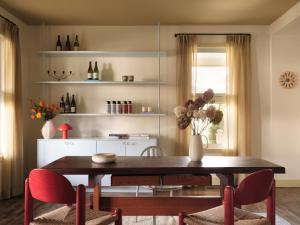 a dining room with a wooden table and chairs at Pinôt Boutique Hôtel in Sutton