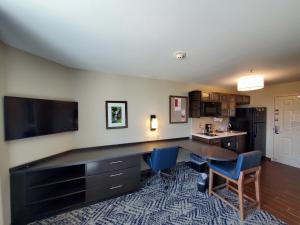 an office with a desk and a table and chairs at Candlewood Suites - Lake Charles South by IHG in Lake Charles
