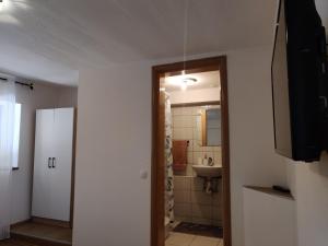 a bathroom with a sink and a toilet and a mirror at Soba Angelina Međugorje in Međugorje