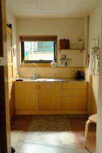 a kitchen with a sink and a window at Tomo 伴 in Tainan