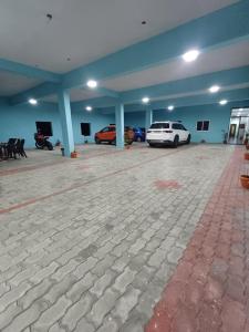 a garage with two cars parked in it at Saai Residency Tiruvannamalai in Tiruvannāmalai