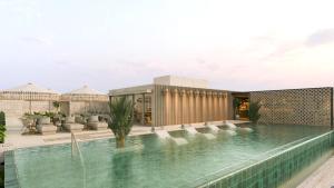 a swimming pool in front of a building at Hotel Indigo Playa del Carmen by IHG in Playa del Carmen