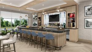 a bar in a restaurant with blue stools at Staybridge Suites Aurora East by IHG in Aurora
