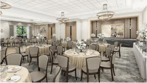 a banquet room with tables and chairs and chandeliers at Staybridge Suites Aurora East by IHG in Aurora