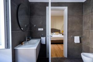 a bathroom with a sink and a mirror at MAMA Luxury in Rome