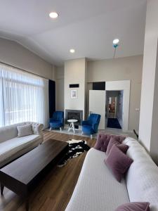 a living room with two couches and a fireplace at Mila Villa Foçaköy in Foca