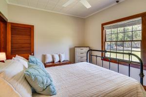 a bedroom with a large bed and a window at Peaceful Patio, Sunroom Pet-Friendly Baldwin Home in Franklin