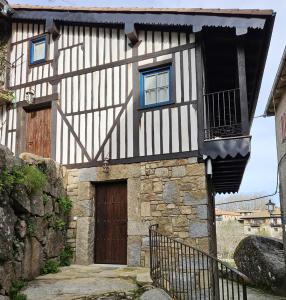 a black and white building with a door at Mural del Castillo II, La Alberca in La Alberca