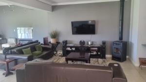a living room with a couch and a fire place at December Holiday Home George in George