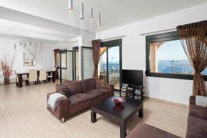 a living room with a couch and a table at Anna Nissaki in Corfu