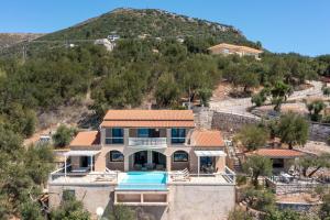 an image of a house with a hill in the background at Anna Nissaki in Corfu