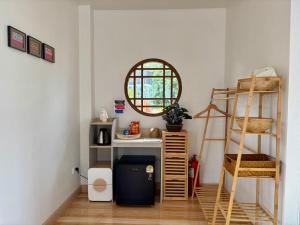 a room with a desk and a mirror and a ladder at เขาลมเย็น in Khao Kho