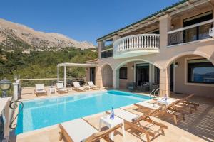 a villa with a swimming pool and a house at Anna Nissaki in Corfu
