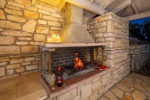 an outdoor brick oven with candles in it at Anna Nissaki in Corfu
