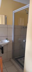 a bathroom with a shower and a sink at Travelers Home in Richards Bay +19 photos