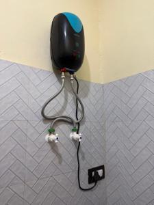 a blow dryer is attached to a wall at Omisha Beach Stay Gokarna in Gokarna