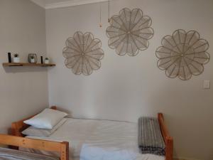 a bedroom with a bed and two lights on the wall at Cenikma Guest Suites - Family Room 1 in East London