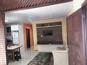 a living room with a couch and a tv and a table at La Casa de Gramado in Gramado